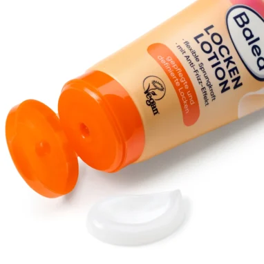 Balea Curl Styling Lotion with open orange flip cap and a small amount of white lotion